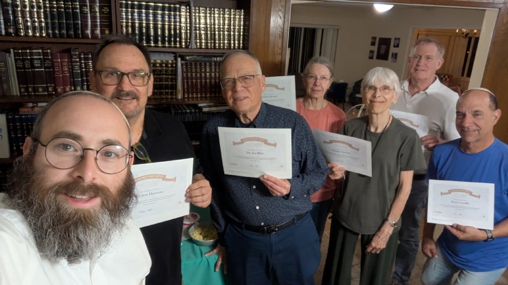 Graduates of the Sinai and Civics course holding their certificates