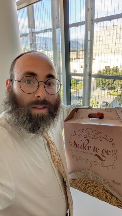Rabbi Stiefel delivering a holiday package to a patient at City of Hope